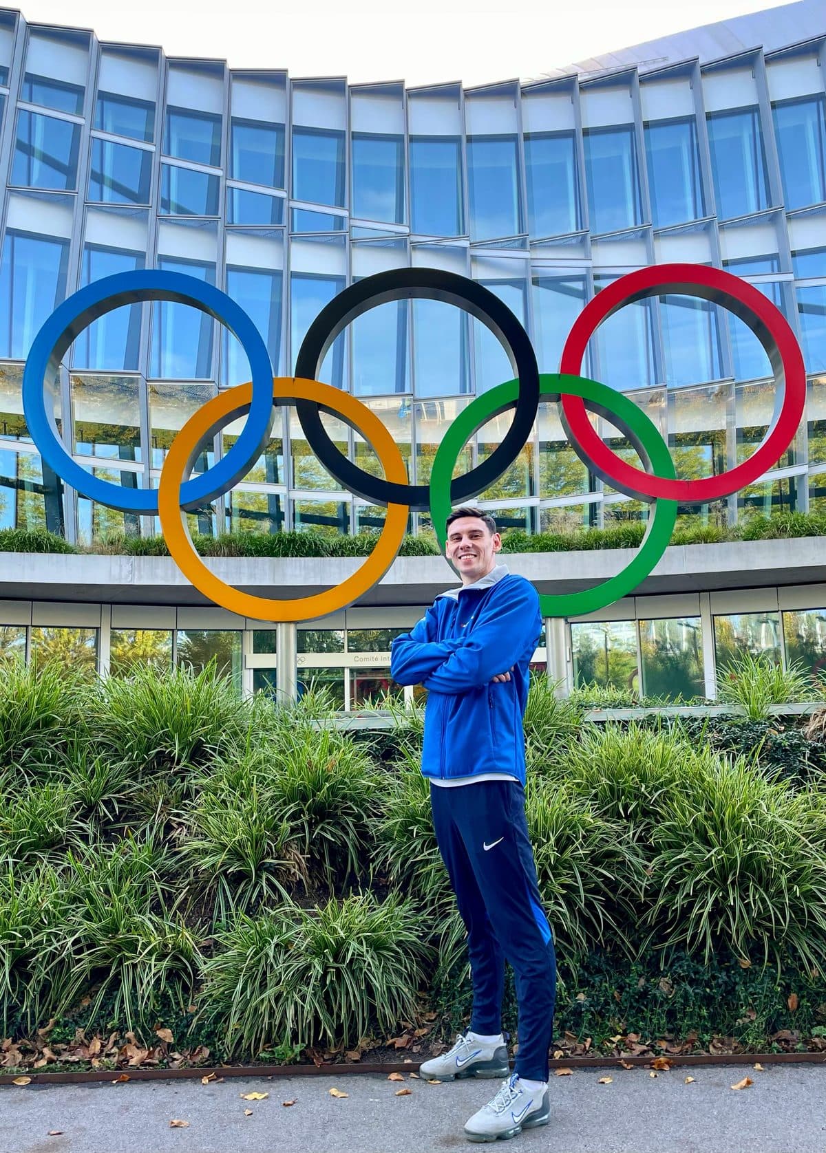 Elijah Everill in front of the Olympic rings